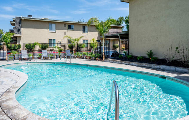 a swimming pool with a building in the background