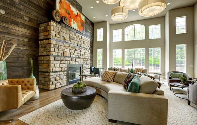 a living room with a large stone fireplace and a large couch