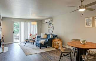 A living room with a blue couch and a wooden table.