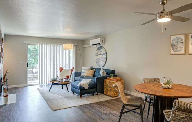 A living room with a blue couch and a wooden table.