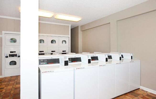 a group of washers and dryers in a laundry room