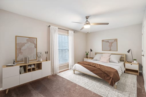 a bedroom with a bed and a ceiling fan