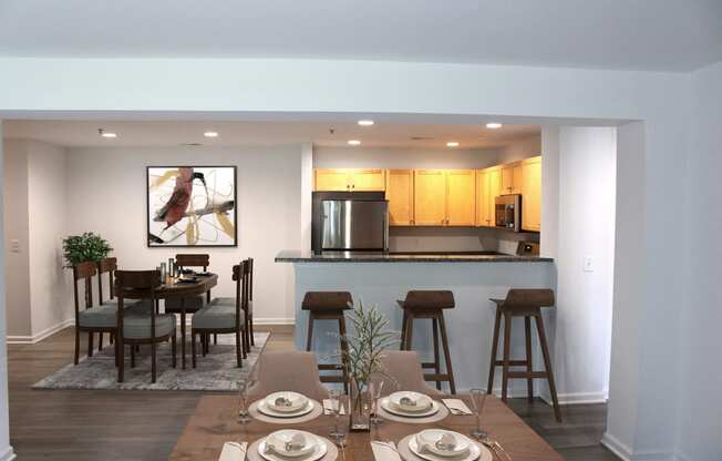 a dining room and kitchen with a table and chairs