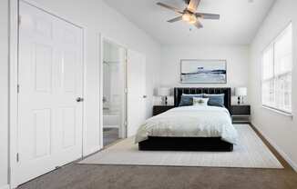 a bedroom with a bed and a ceiling fan