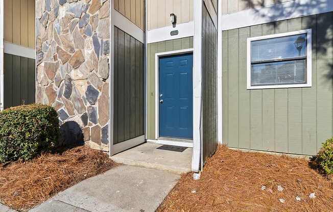 Element at 4411 Macon Apartments A blue door is the focal point of this image.