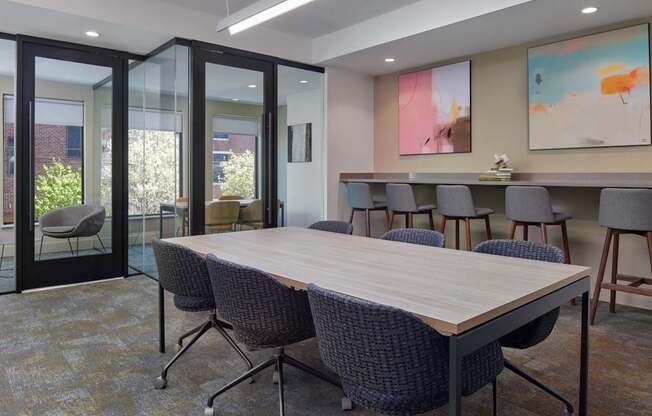 A conference room with a long table and chairs.