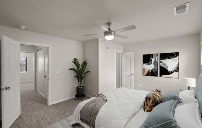 a bedroom with a large bed and a ceiling fan