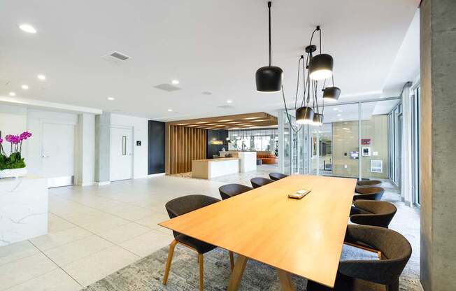 A conference room with a long table and chairs.