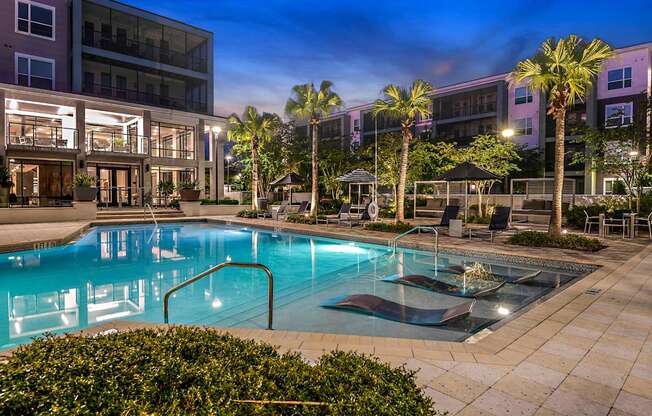 a swimming pool at night at the grove apartments