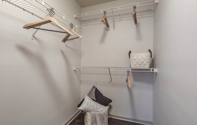 a walk in closet with shelves and hooks and a basket on the wall at Gwinnett Pointe, Georgia