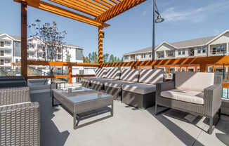 a patio with couches and tables and a glass coffee table