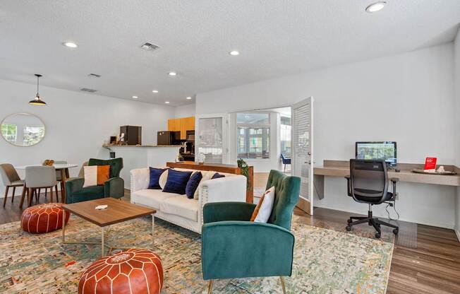 A living room with a green chair and a white couch.