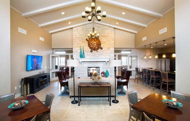 A large dining room with a fireplace and a television.