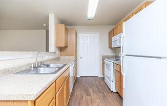 a kitchen with a stove sink and refrigerator