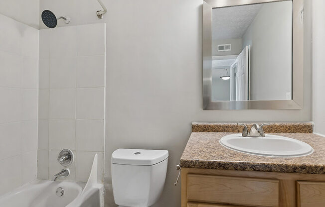a white bathroom with a sink toilet and a shower
