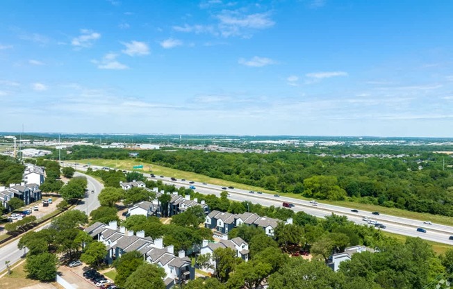 A suburban area with houses and a highway.