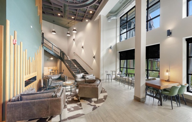 a lobby with couches chairs and tables and a staircase