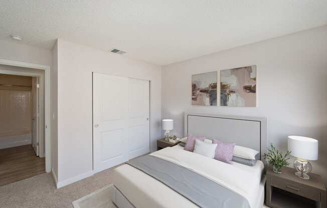 West Oaks apartments bedroom with large closet, bed and two nightstands.