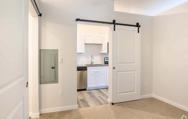 entry to kitchen with sliding white door at Brownstones at Palisade Park Townhomes, Broomfield, CO