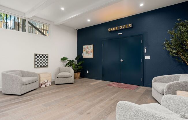 A waiting room with chairs and a sign that says "Game Over".