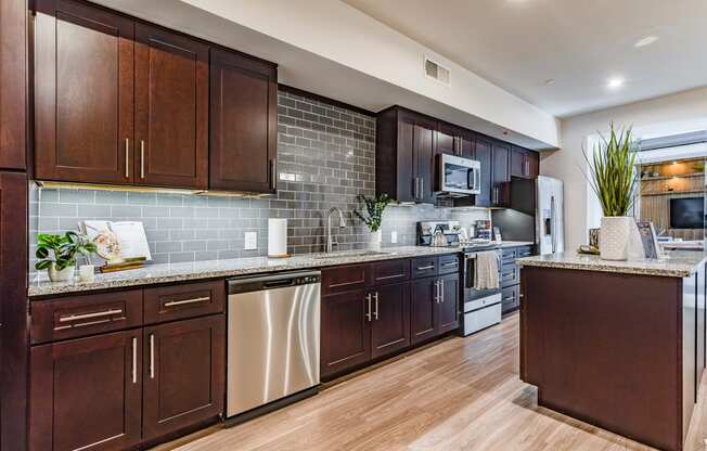 a kitchen with wooden cabinets and stainless steel appliances