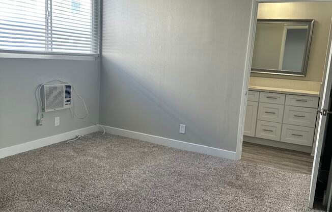 an empty room with carpet and a window