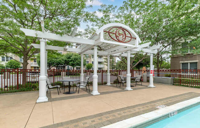 a gazebo with tables and chairs next to a swimming pool at Pier Village Apartments, New Jersey, 07740