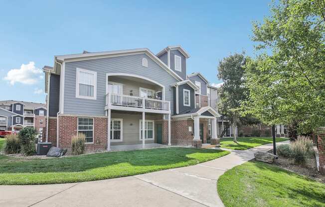 A two-story house with a balcony on the second floor.