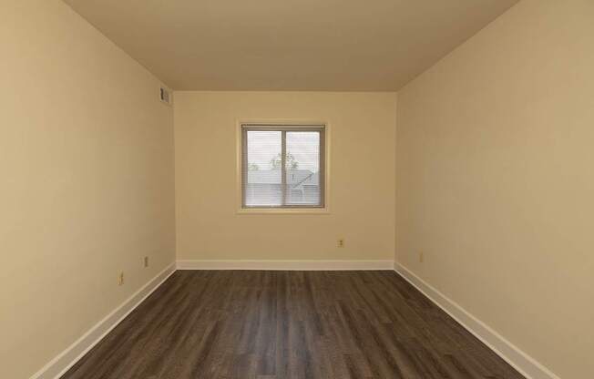 A room with wooden floors and a window.