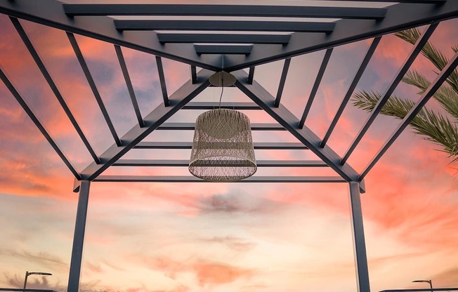 A patio with a couch and a table under a roof.