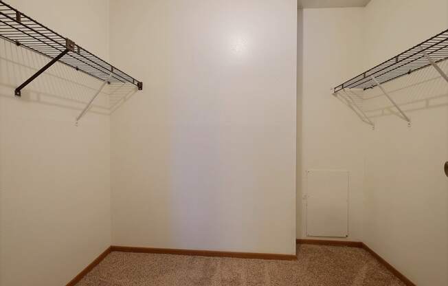 a room with two hanging racks on the wall and a closet at France, Fargo, 58103