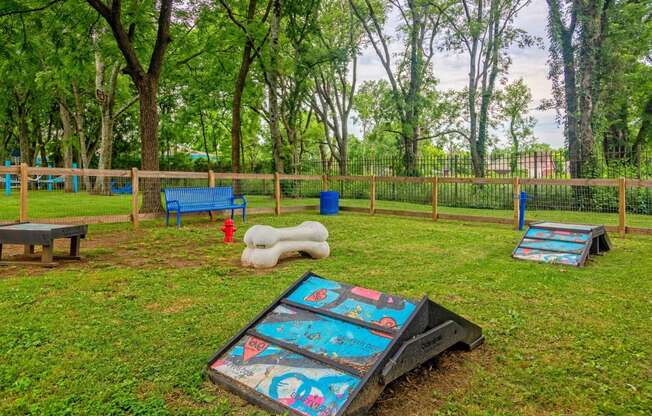 Apartments Nashville TN - The Canvas - Gated Bark Park with Obstacle Equipment, Bench Seating, and Lush Grass