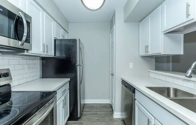 Experience a modern kitchen at Cali Crossing Apartments, featuring sleek stainless steel appliances, ample counter space, and elegant cabinetry. Elevate your living space today! Schedule a tour and see your new home.