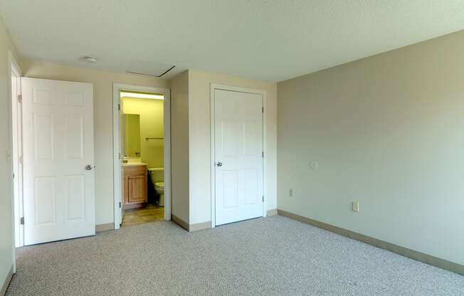 Carpeted Bedroom With Attached Bath at Pondside at Littleton Apartments.