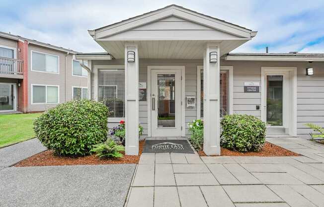 A small building with a porch and a sign that says
