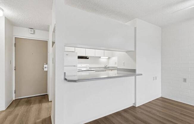 A kitchen with a sink and a counter.