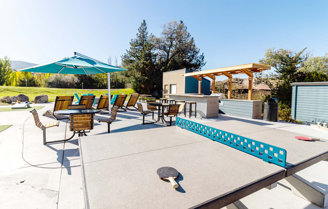 large patio with tables and chairs and a ping pong table