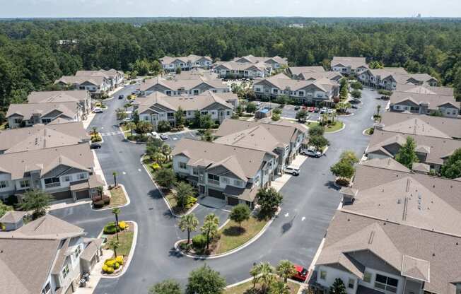 an aerial view of a neighborhood of houses with trees