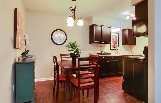 A kitchen with a table and chairs.