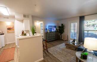 A living room with a white sofa and a wooden coffee table.