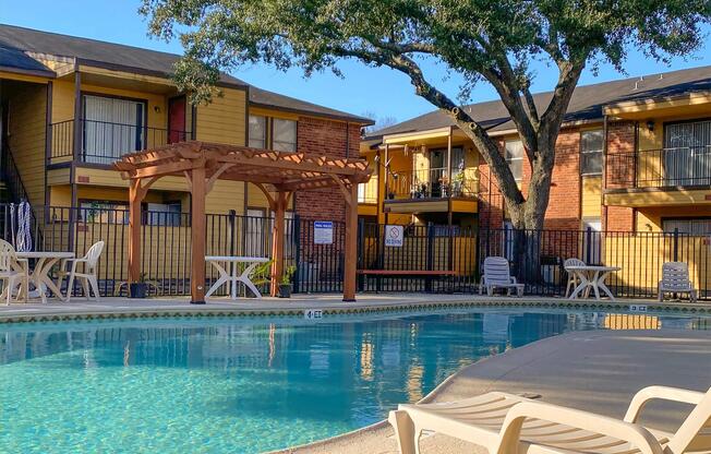 a house with a pool in front of a building