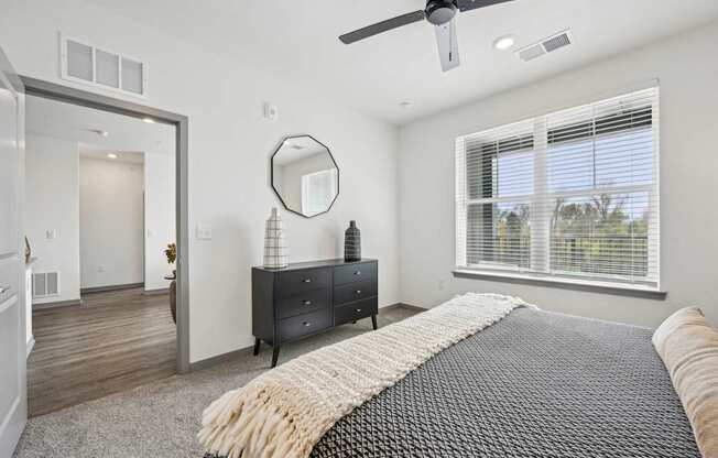 a bedroom with a bed and a ceiling fan at The Quarry Luxury Apartment Homes, Fort Collins, CO, 80526