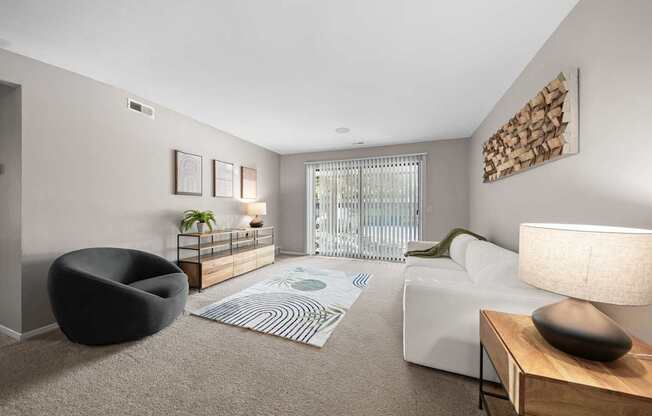 Spacious Living Room with Sliding Glass Door at Lakeside Village Apartments Clinton Township MI