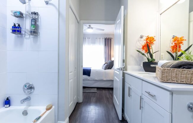 a bathroom with a shower and a sink and a mirror