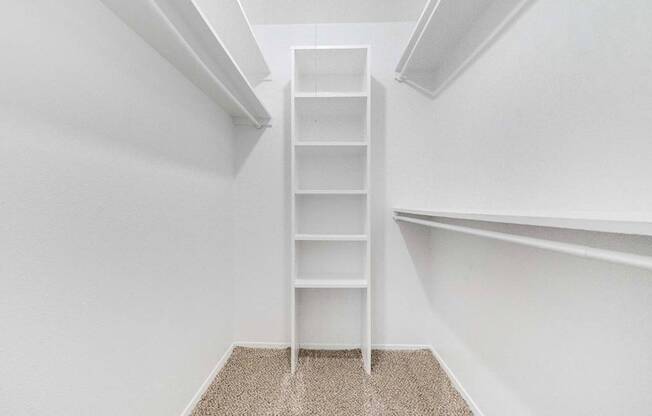 a ladder in a closet in a room with white walls