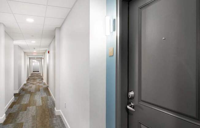 Parkside Commons hallway with a blue door and a carpeted floor.