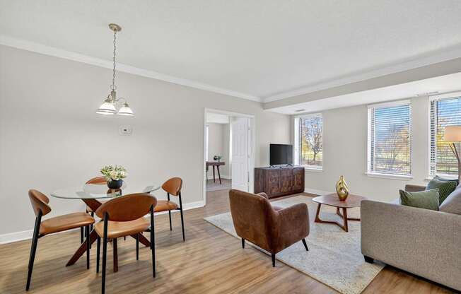 A living room with a dining table and chairs.
