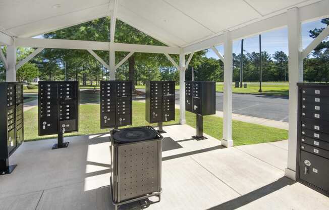 a group of servers in a pavilion with trees in the background