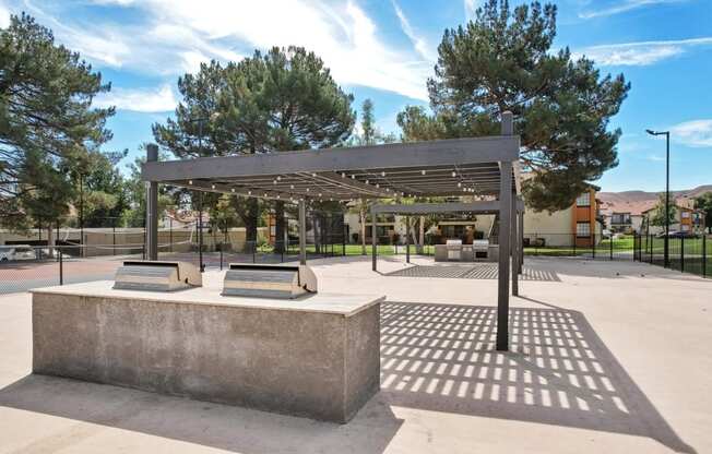 a park with benches and a shade