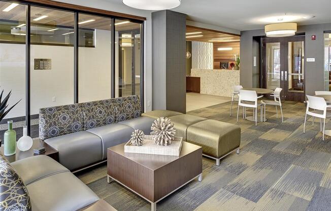 Be @ Axon Green Lounge Area with couches, chairs, and coffee table
